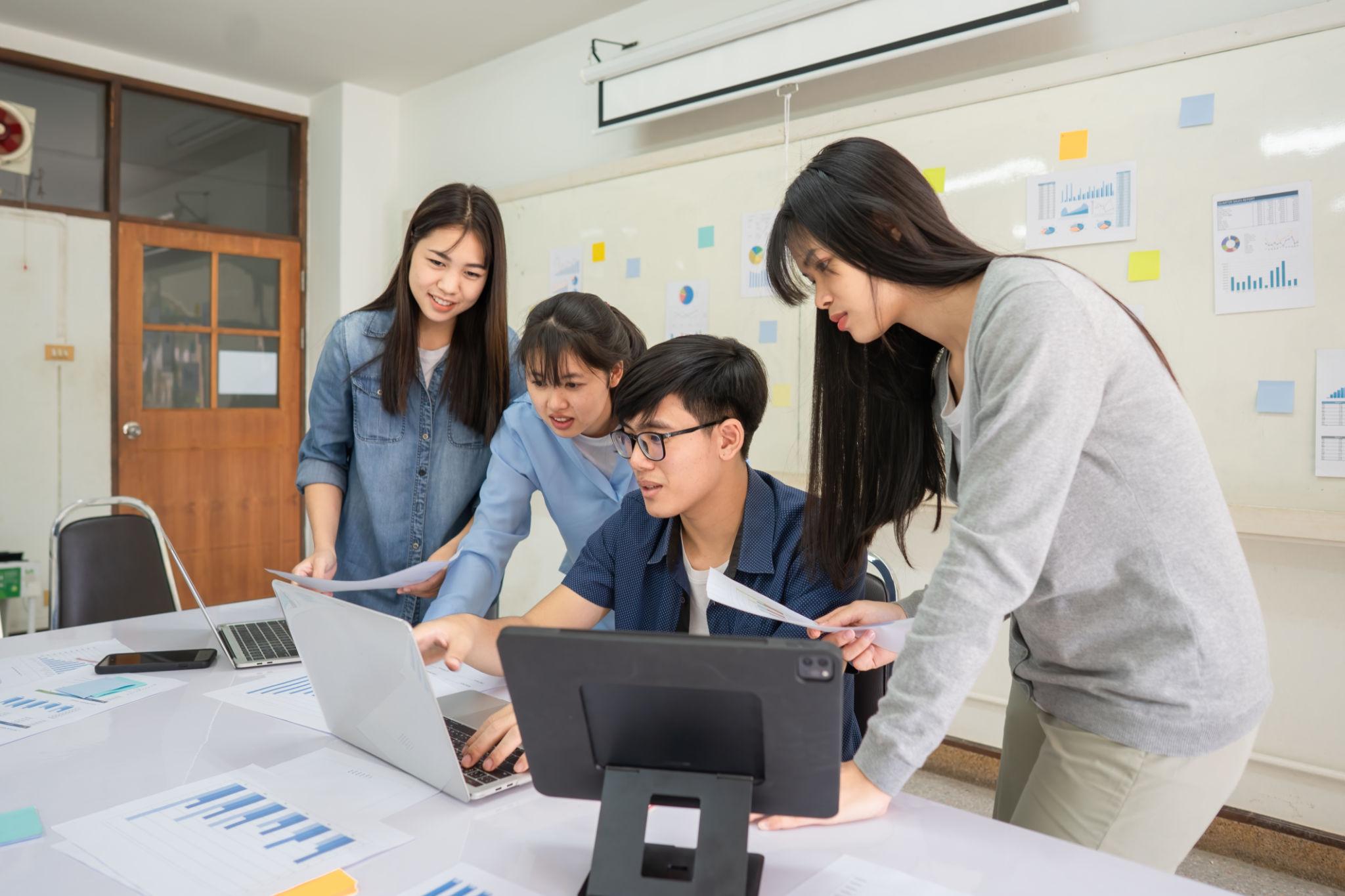 Students collaborating on human resource and supply chain management studies